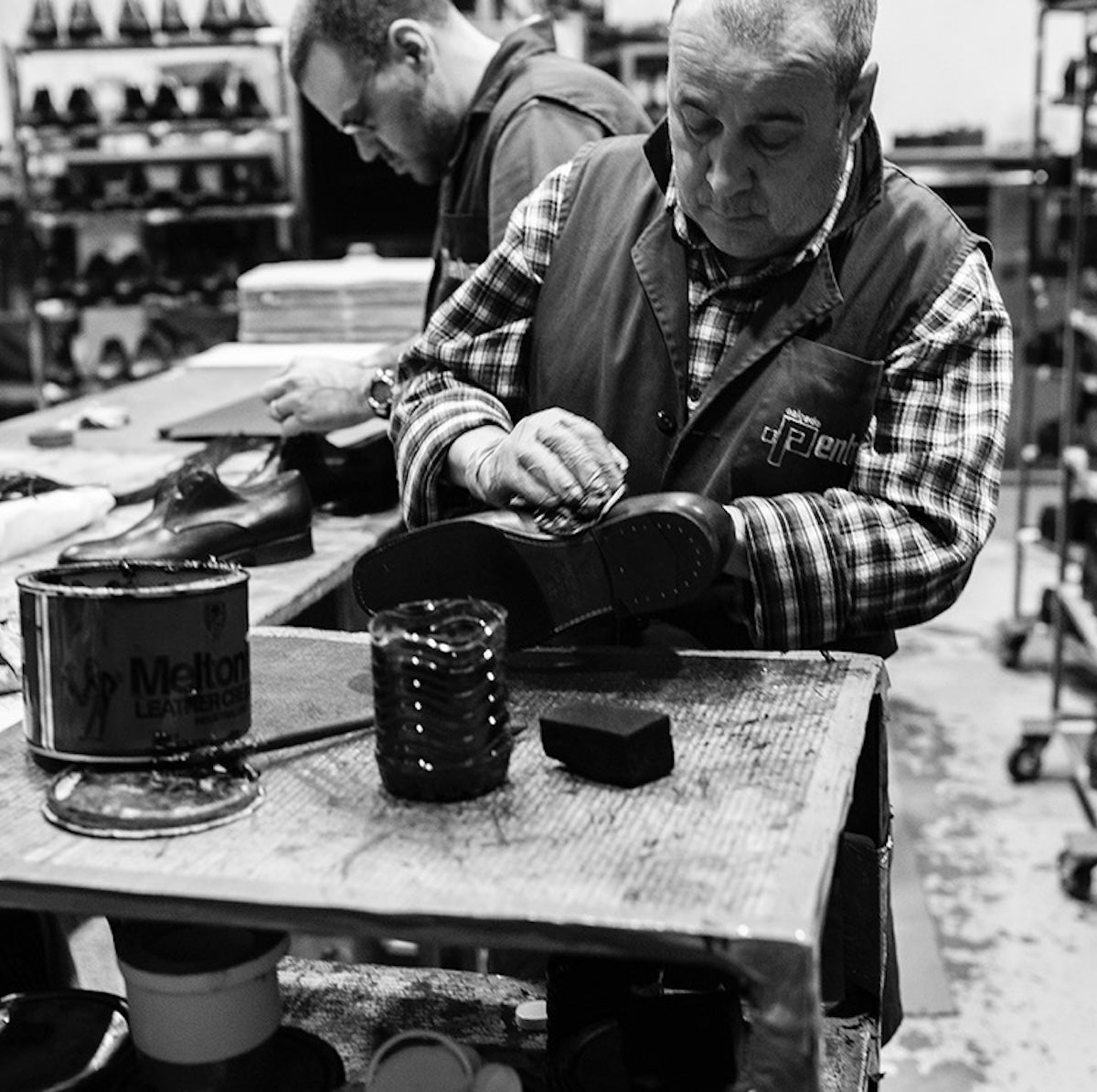 Two men working on Bum Society leather boots the factory