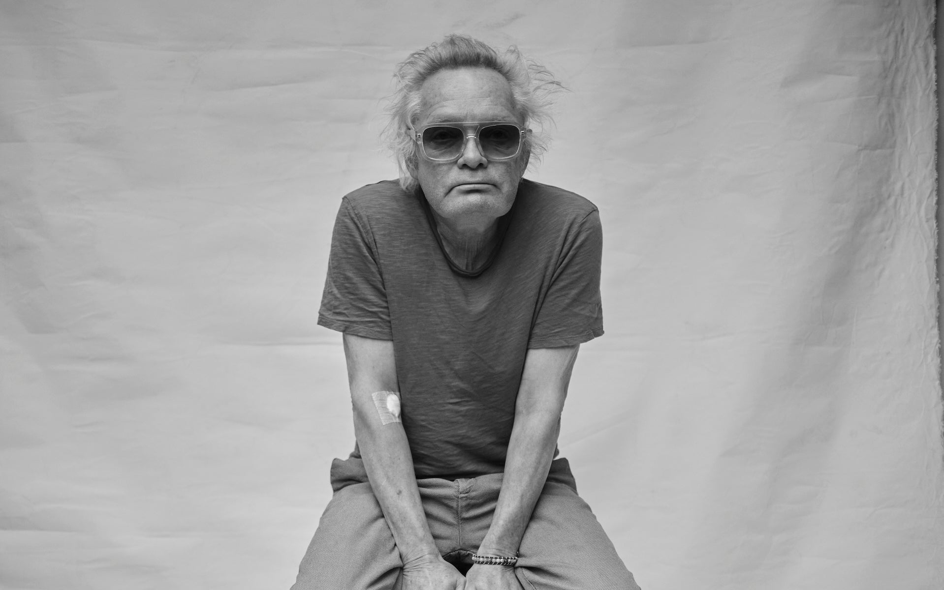 Claes Bondelid wearing sunglasses and a t-shirt against a plain background in Stockholm studio