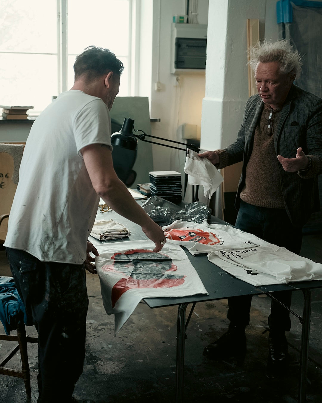 Jesper Waldersten and Claes Bondelid in a room with t-shirt print stroke offs on a table