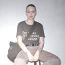 Person wearing a Bum Society SOMBFAH t-shirt, sitting on a stool against a plain background color:ink
