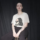 Person wearing a Waldersten x Bum Society original artwork Lady Dead for Waldersten x Bum Society collaboration on a stool against a black background color:mud