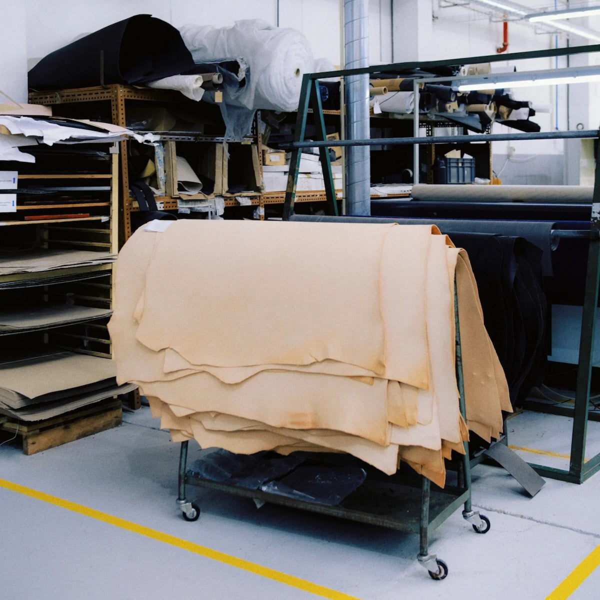 Stack of raw hides on a cart in a tannery setting