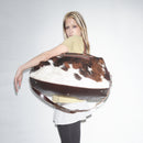 Person holding a Bum Society pony hair duffle bag against a plain background color:dandy brown 