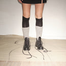 Person wearing black knee-high socks with white patterns and Bum Society Ruby Thursday boot Shiny Black color:shiny black