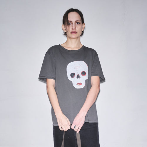 Person wearing a dark gray t-shirt with original Waldersten x Bum Society print Cry Baby color:ink