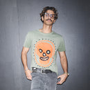 Man wearing a Cypress t-shirt with Baby Cillian print, original Waldersten artwork for collaboration with Bum Society against a dark background color:cypress
