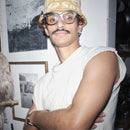 Person wearing a Bum Society x Vbrani crochet bucket hat indoors against wall with art color:lucky yellow